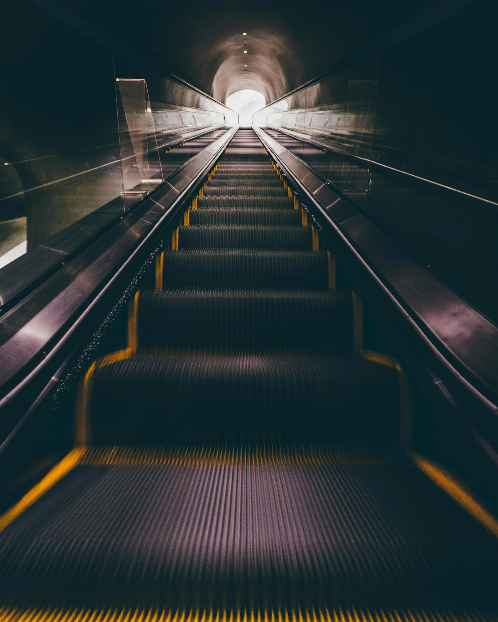 an escalator with a light at the end of it, an album cover, unsplash contest winner, hypermodernism, lgbtq, dark underground, about to step on you, passengers