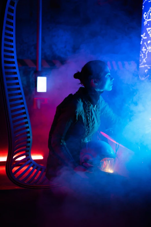 a man that is sitting down in the dark, interactive art, blue and white and red mist, inside an alien jungle, dramatic theming, dna