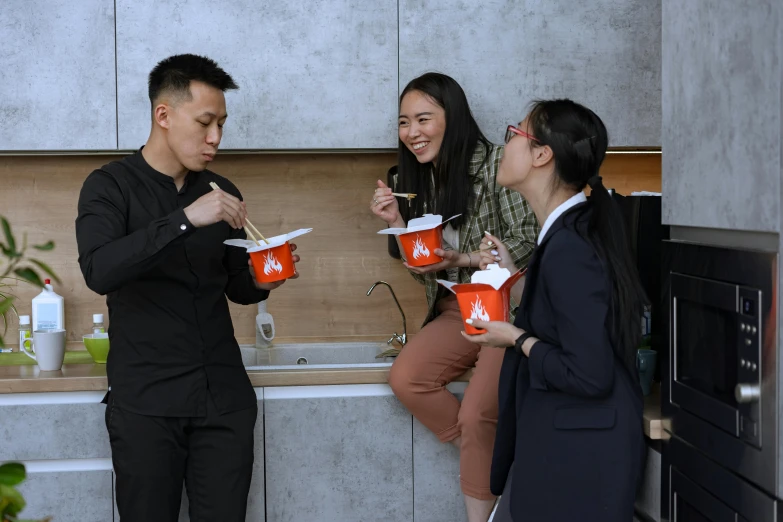 a group of people standing in a kitchen, eating ramen, holding a bucket of kfc, jordan grimmer and natasha tan, profile photo