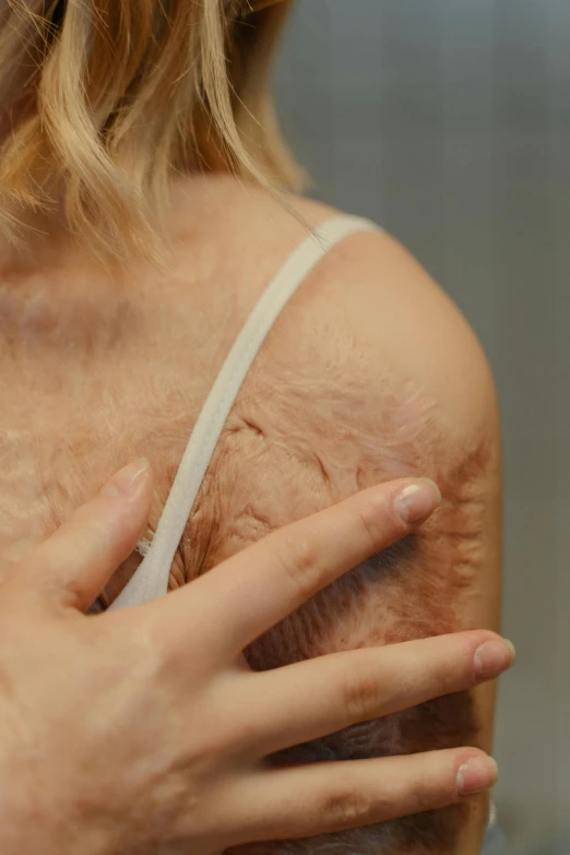 a close up of a person holding a cell phone, furr covering her chest, old scars, promo image, raising an arm