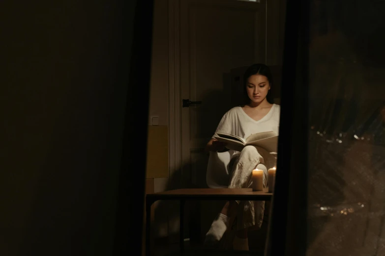 a woman sitting in a chair reading a book, pexels contest winner, hyperrealism, in the bedroom at a sleepover, looking in a mirror, light separated from dark, wearing white pajamas