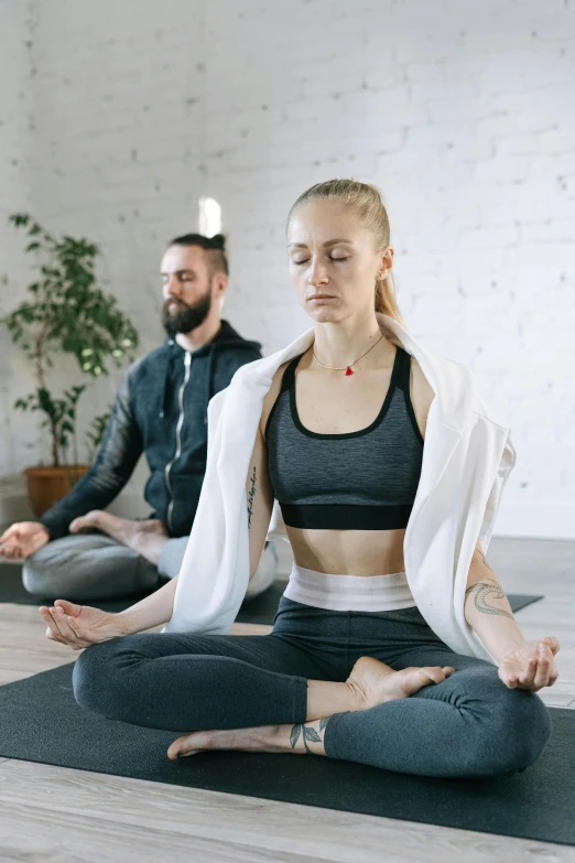 a group of people sitting on top of a yoga mat, profile image, wearing a tracksuit, trending photo, two people