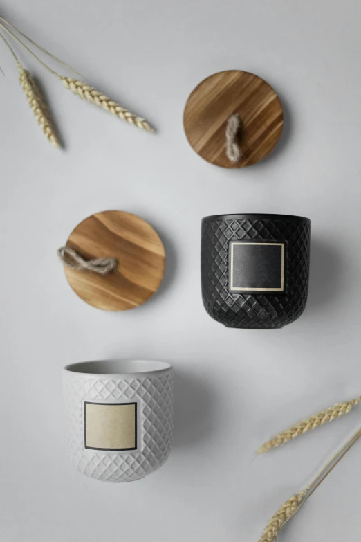 three candles sitting next to each other on a table, detailed product image, wood and gold details, wide overhead shot, large jars on shelves