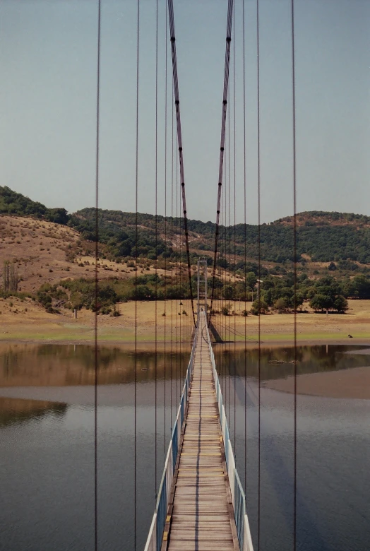 a long suspension bridge over a body of water, inspired by Christo, renaissance, hollister ranch, 3 5 mm slide, kano), loosely cropped