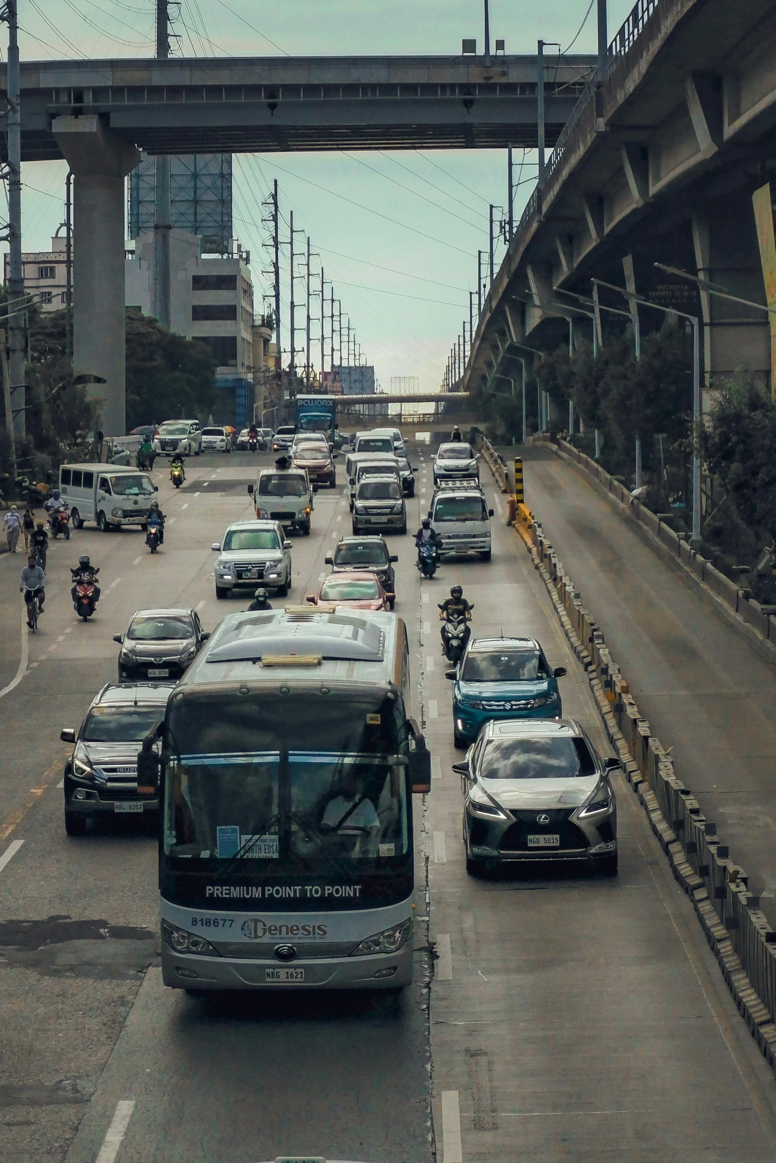 a city street filled with lots of traffic, by Alejandro Obregón, pexels contest winner, philippines, overpass, 🚿🗝📝, vw bus on a street