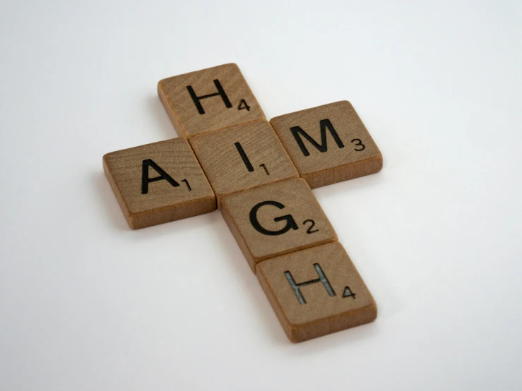 a cross made out of scrabbles sitting on top of a table, inspired by Hugh Hughes, unsplash, letterism, laughing man, hgh, magnesium, hi definition