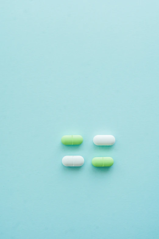 green and white pills on a blue background, unsplash, antipodeans, threes, alien capsules, girls, 4 colors