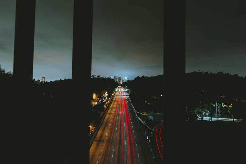 a view of a city at night from a bridge, unsplash contest winner, mulholland drive, car lights, window view, instagram picture