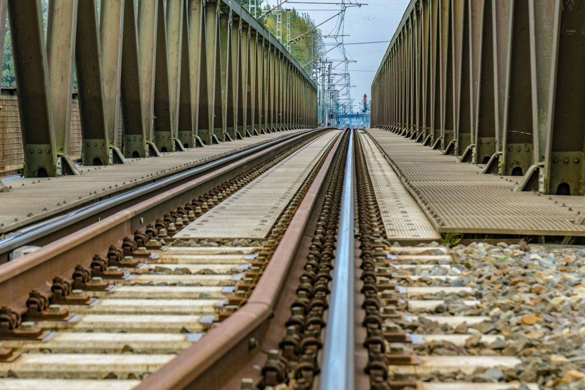 a couple of train tracks that are next to each other, a portrait, unsplash, renaissance, metallic bridge, wikimedia commons, chemrail, eyelevel perspective image