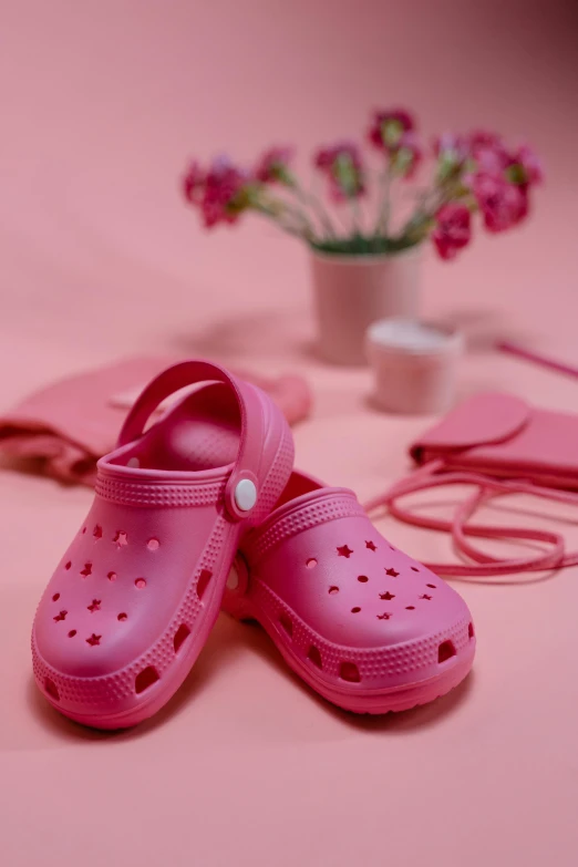 a pair of pink shoes sitting on top of a table, by Lilia Alvarado, pexels contest winner, plasticien, made of rubber, 5k, spring theme, maternal