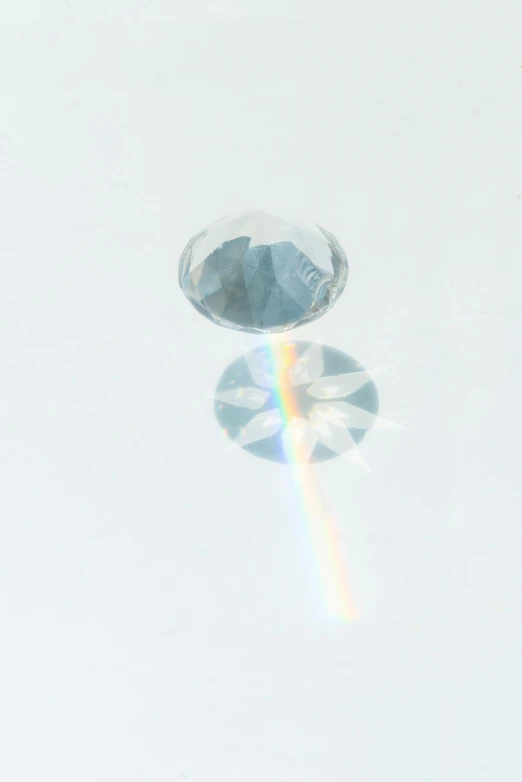 a close up of a diamond on a white surface, a hologram, moonbow, 1/160s, detailed product image, zoomed out