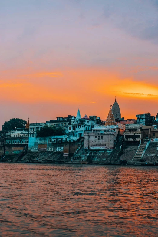 a large body of water next to a city, by Rajesh Soni, during sunset, temple, datapipeline or river, exterior