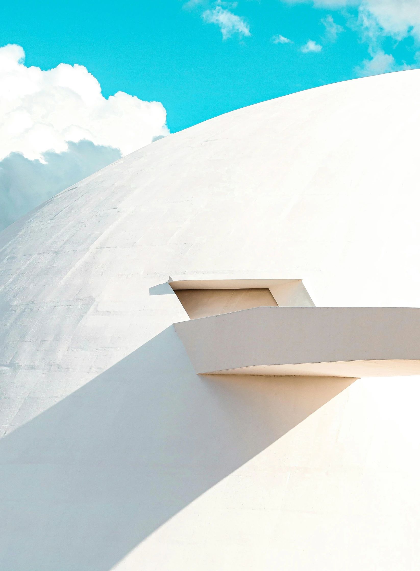 a man riding a snowboard down the side of a snow covered slope, inspired by Tadao Ando, unsplash contest winner, hypermodernism, rounded roof, james turrell building, profile image, bright white porcelain