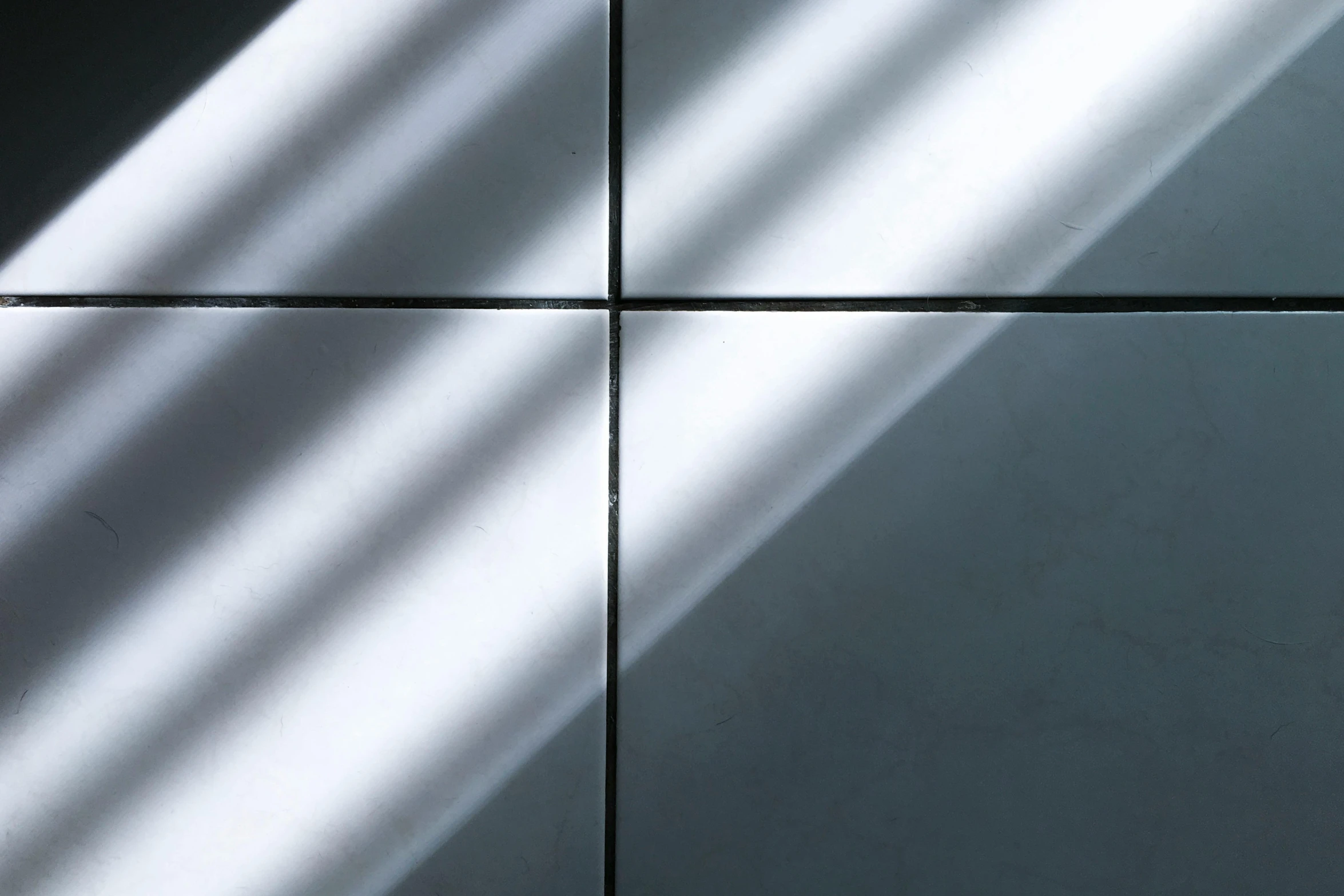 a white toilet sitting inside of a bathroom next to a mirror, an album cover, inspired by Bauhaus, unsplash, light and space, shadow gradient, tiles, metal shaded, difractions of light