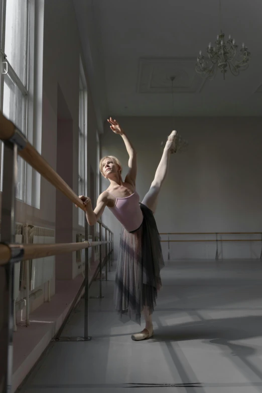 a woman that is standing in the middle of a room, by Elizabeth Polunin, trending on unsplash, arabesque, classic dancer striking a pose, square, alexey egorov, grey