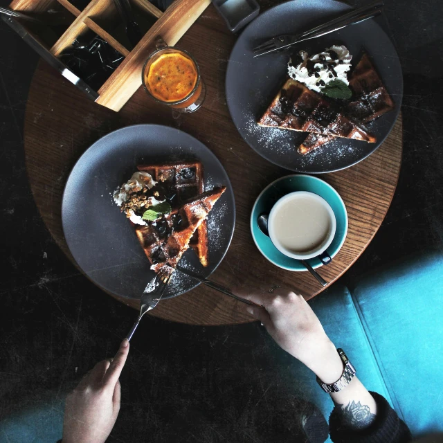 a table topped with plates of food and a cup of coffee, 2 people, copper and deep teal mood, “ iron bark, food pov