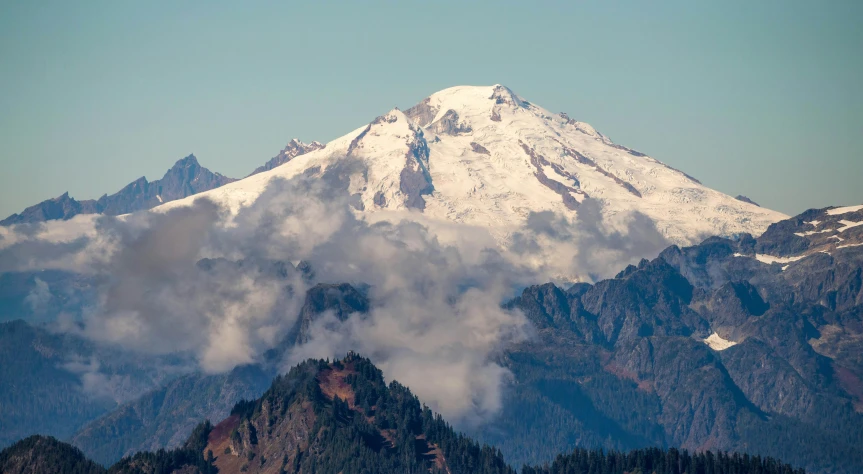 a large mountain covered in snow and clouds, a picture, by Jim Nelson, trending on unsplash, renaissance, seattle, zoomed in, fall season, tall thin