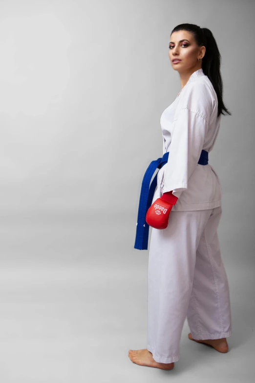 a woman in karate gear posing for a picture, official product photo, blue or red, taken in 2 0 2 0, white