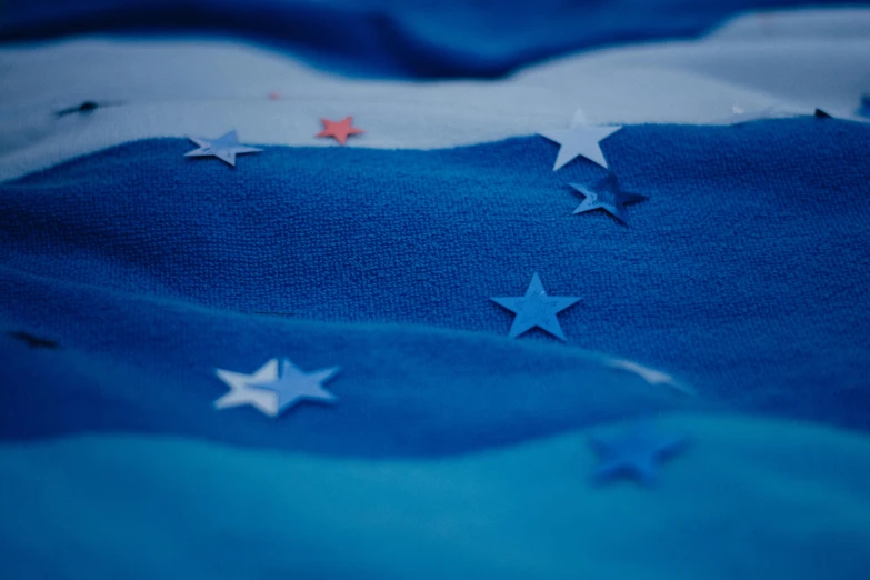 a close up of an american flag with stars, by Matija Jama, unsplash, figuration libre, blue hoodie, azores, european union, blue-fabric