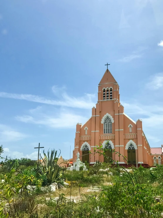 a church sitting on top of a lush green hillside, varadero beach, 🦑 design, red building, alabaster gothic cathedral