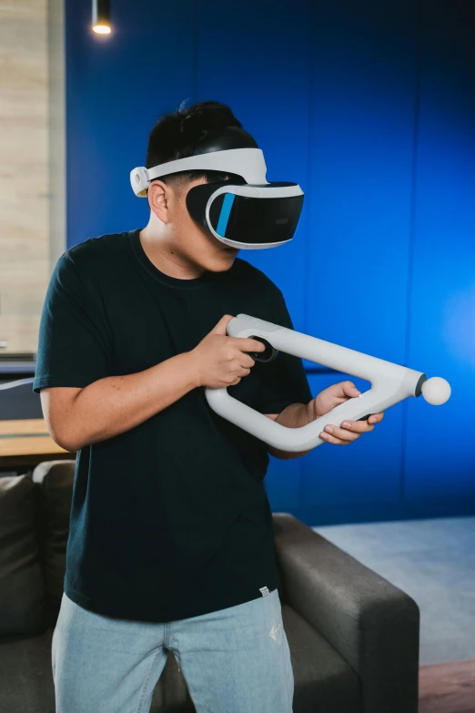 a man standing in a living room holding a video game controller, a hologram, inspired by Leng Mei, sleek oled blue visor for eyes, oculus quest 2, fully body shot, vanilla