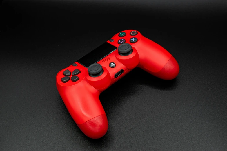 a red video game controller on a black surface, playstation 4, high resolution print :1 red, hyperrealistic n- 4, wearing red