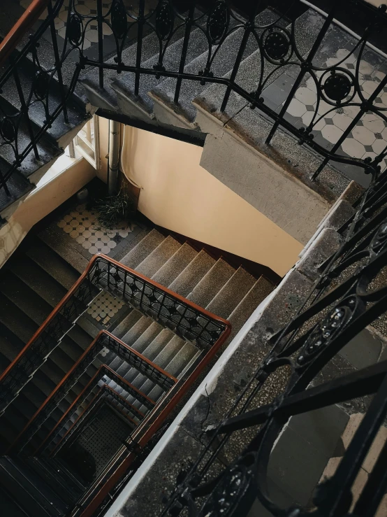 a couple of stairs that are next to each other, pexels contest winner, art nouveau, low quality photo, top down photo, an escape room in a small, budapest