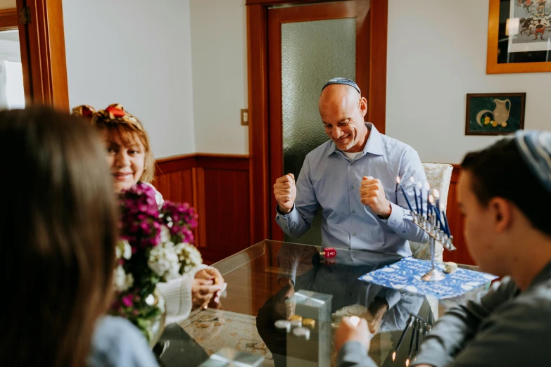 a group of people sitting around a table, flowers, benjamin netanyahu, getting ready to fight, unsplash contest winning photo