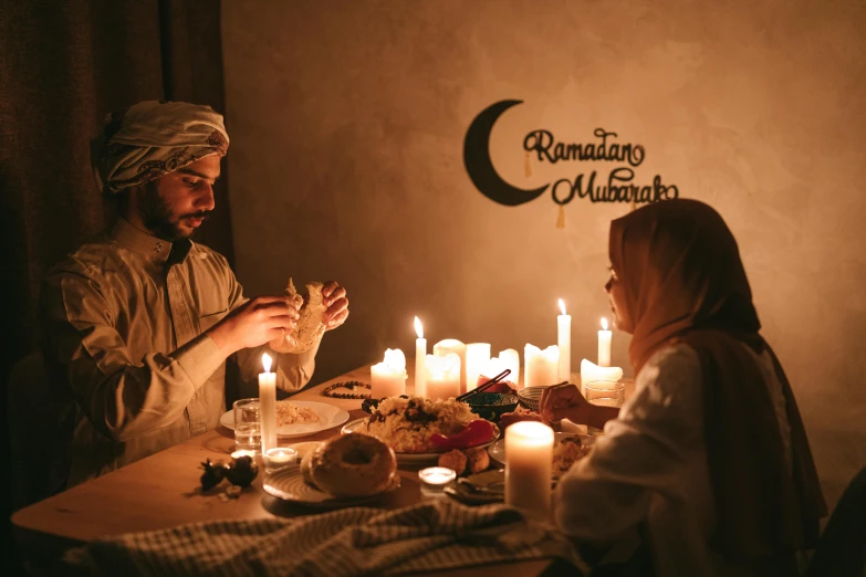 a man and a woman sitting at a table with candles, pexels contest winner, hurufiyya, islamic, ☁🌪🌙👩🏾, ready to eat, 1 5 0 4