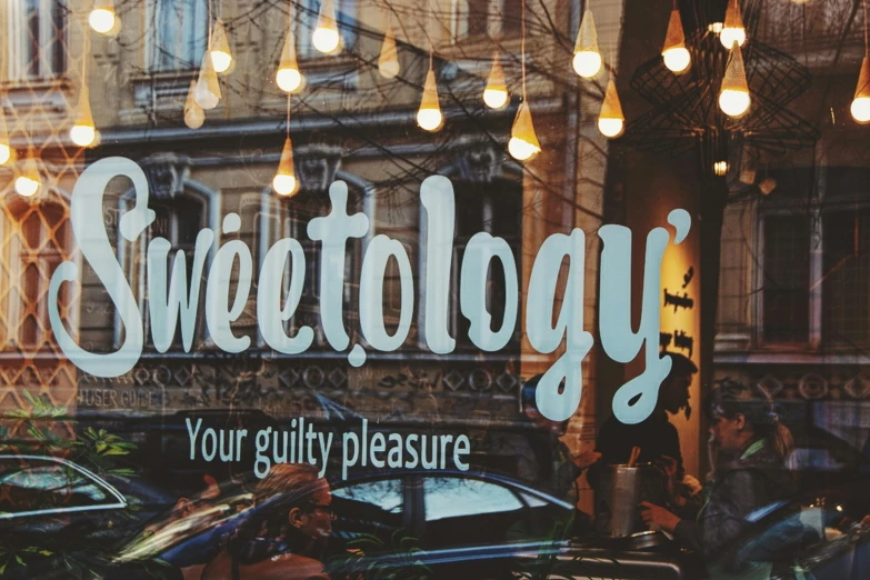 a store window with a sign that says sweetology, a cartoon, trending on pixabay, analogue photo, profile picture 1024px, poltergeist, havrylo pustoviyt