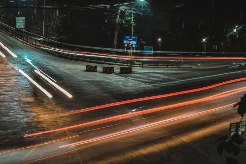 a person riding a bike down a street at night, speed lines, cars on the road, thumbnail, stacked image