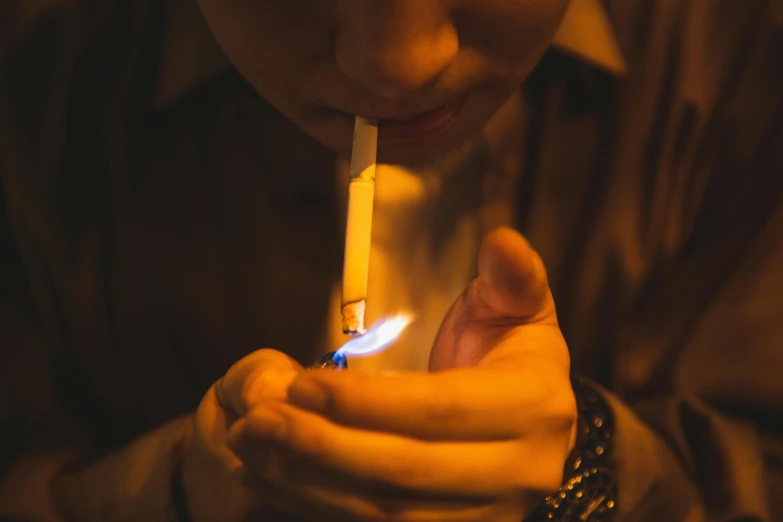 a person holding a lighter in their hand, inspired by Elsa Bleda, pexels contest winner, hyperrealism, gendo ikari smoking a joint, mid night, profile image, candlelit