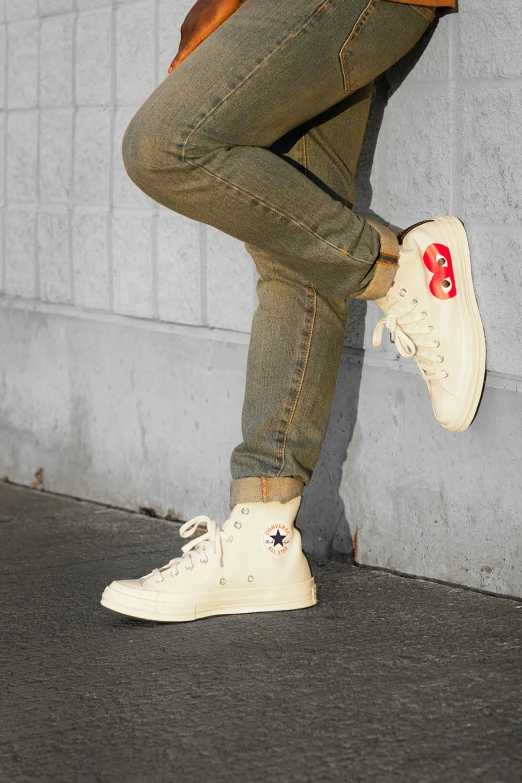 a man riding a skateboard up the side of a wall, an album cover, by Everett Warner, trending on pexels, pop art, wearing red converse shoes, cream, on a pale background, miro