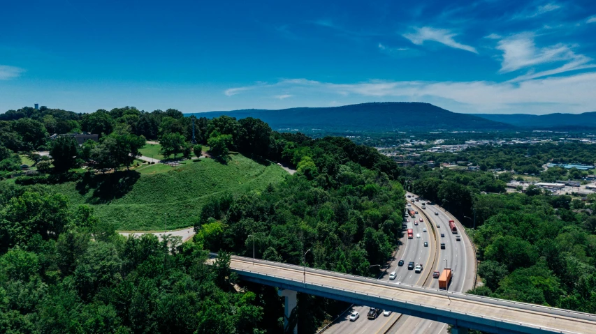 a view of a highway from the top of a hill, by Dan Frazier, visual art, 4k panoramic, advertising photo, bridges, thumbnail