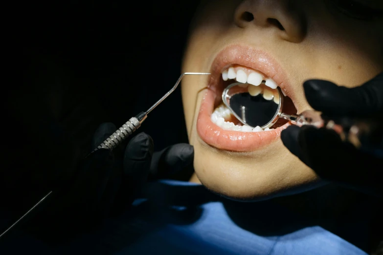 a woman getting her teeth examined by a dentist, by Adam Marczyński, shutterstock, hyperrealism, dark contrast, long open black mouth, extreme detail photo quality, jewelry