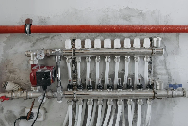 a bunch of pipes that are connected to a wall, pexels contest winner, liquid cooling, passive house, red mechanical body, gif