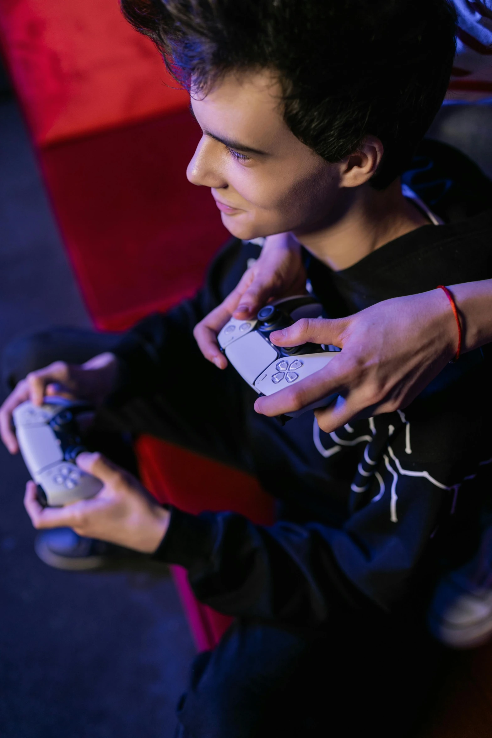 a young man holding a nintendo wii game controller, taken with sony a7r camera, teenager hangout spot, unreal engine tech demo, gaming chair