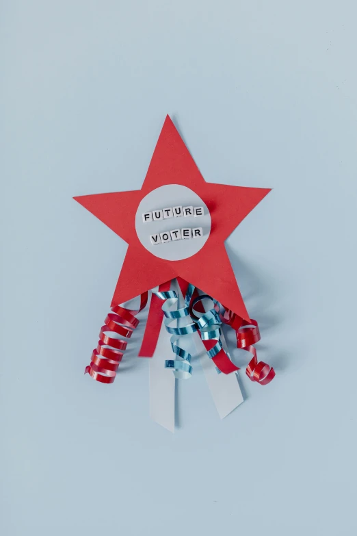 a red star sitting on top of a piece of paper, streamers, future coder, courtesy of moma, presidental elections candidates