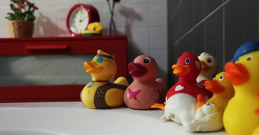 a row of rubber ducks sitting on top of a sink, the clangers, slide show, cheburashka, vinyl designer toy