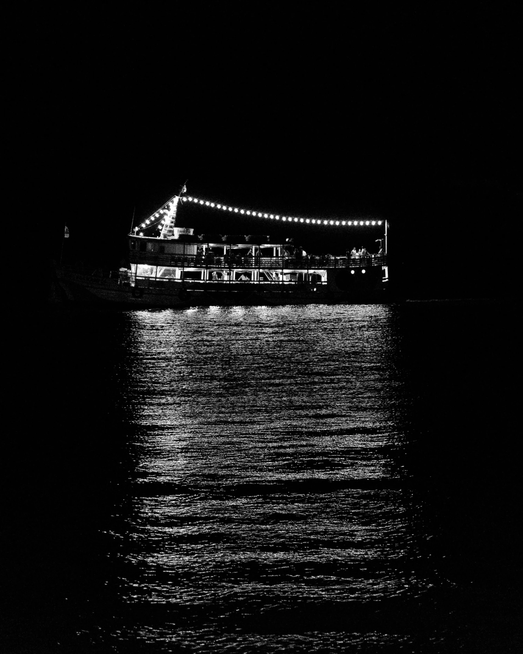 a boat that is in the water at night, a black and white photo, floating lights, profile image, holiday season, server