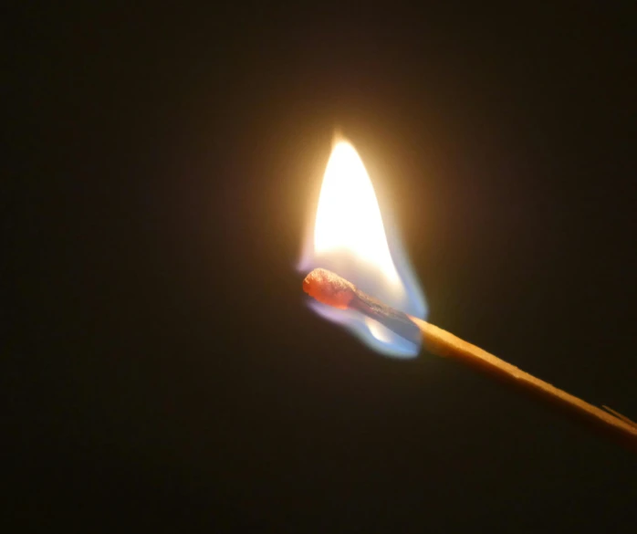 a close up of a lit matchstick on a black background, pexels, on a gray background, made of glowing wax, instagram photo, geforce rtx 3090 on fire