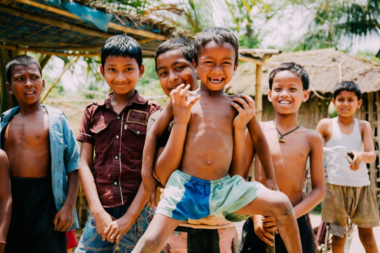 a group of young boys standing next to each other, pexels contest winner, hurufiyya, avatar image, playful smile, cambodia, background image