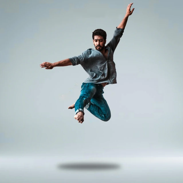 a man jumping in the air with his arms outstretched, by Saurabh Jethani, arabesque, on simple background, a portrait of rahul kohli, full body 8k, carson ellis