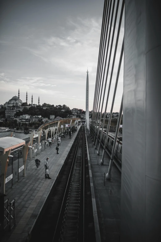 a black and white photo of a train station, by irakli nadar, color graded, minarets, sky bridge, view