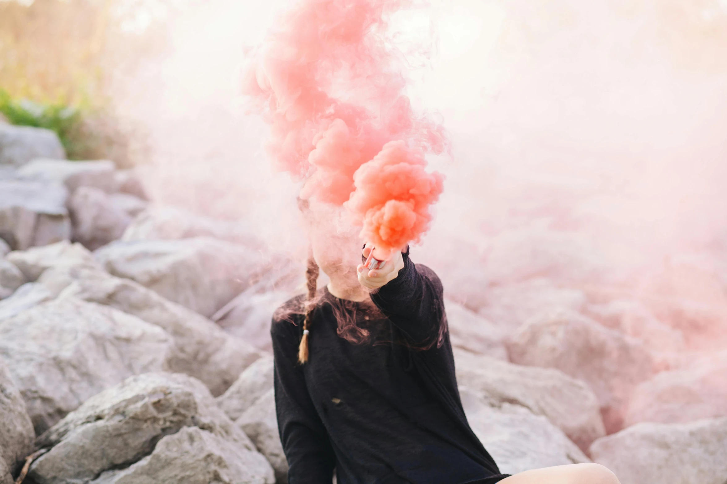 a woman sitting on top of a pile of rocks, pexels contest winner, surrealism, pink smoke, barbecuing chewing gum, profile picture, :6 smoke grenades