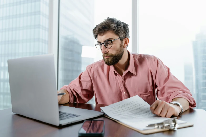 a man sitting at a desk in front of a laptop, a screenshot, pexels contest winner, scruffy man, lachlan bailey, studious, people at work