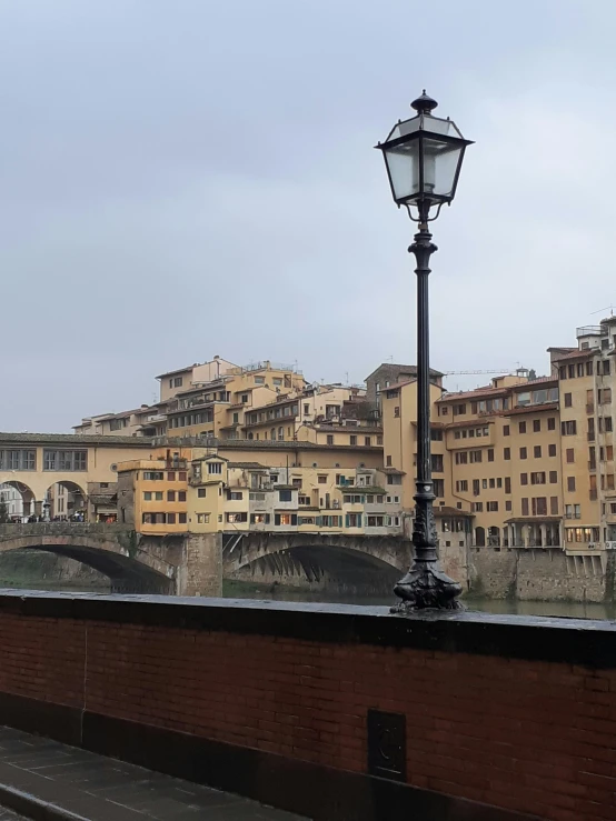a bridge over a river with buildings in the background, a photo, renaissance, style of michaelangelo, overcast!!!, slide show, pov photo