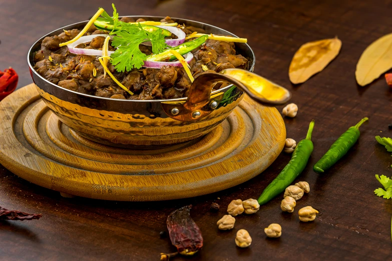 a bowl of food sitting on top of a wooden table, by Julia Pishtar, bollywood, high resolution product photo, fine dining, goat