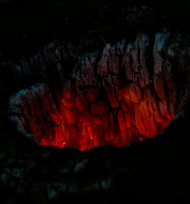 a close up of a fire in a grill, an album cover, by Elsa Bleda, hurufiyya, cave reflecting in the lava lake, tooth wu : : quixel megascans, taken with sony alpha 9, red glowing veins