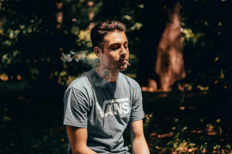 a man sitting on a bench smoking a cigarette, pexels contest winner, wearing a marijuana t - shirt, woodlands, avatar image, lush vista